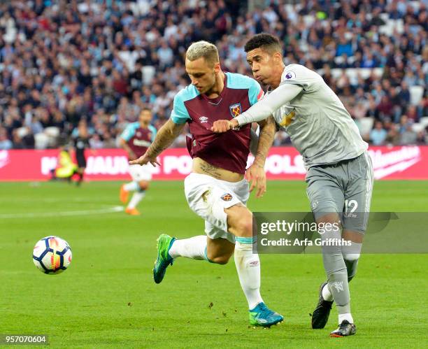 Marko Arnautovic of West Ham United in action with Chris Smalling of Manchester United during the Premier League match between West Ham United and...