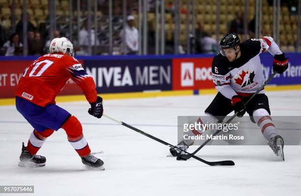 Ken Andre Olimb of Norway and Ryan Pulock of Canada battle for the puck during the 2018 IIHF Ice Hockey World Championship Group B game between...