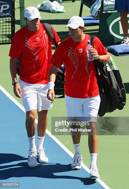 Bob Bryan and Mike Bryan of the USA leave the court after their defeat to Horacio Zeballos of Argentina and Rogier Wassen of the Netherlands in their...