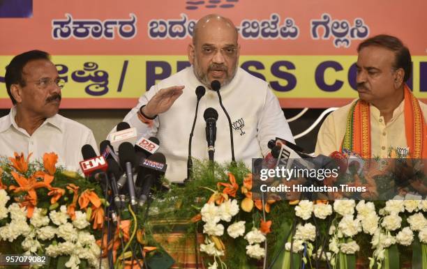 Bharatiya Janata Party national president Amit Shah speaks to media as the Union minister Ananth Kumar and Sadanand Gowda looks on during BJP press...