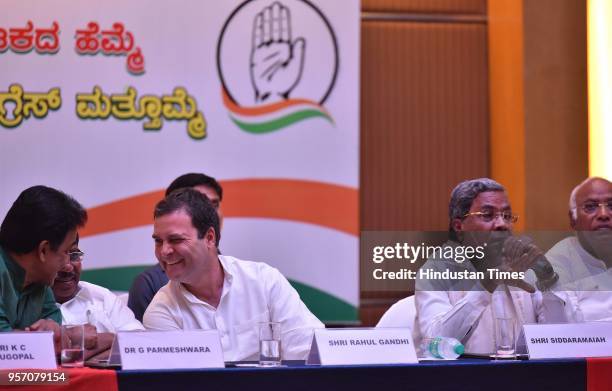 All India Congress Committee president Rahul Gandhi shares a light moment with Karnataka Pradesh Congress Committee president G Parmeshwara and K C...