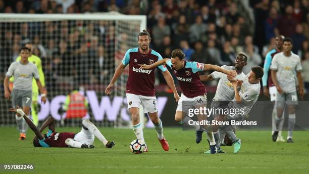 Mark Noble of West Ham United is fouled by Ander Herrera of Manchester United during the Premier League match between West Ham United and Manchester...