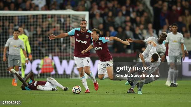 Mark Noble of West Ham United is fouled by Ander Herrera of Manchester United during the Premier League match between West Ham United and Manchester...