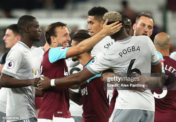 Mark Noble of West Ham United and Juan Mata of Manchester United share a joke after the match during the Premier League match between West Ham United...