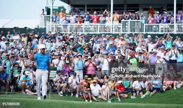 Tiger Woods of the United States reacts to his eagle on the ninth green during the first round of THE PLAYERS Championship on the Stadium Course at...