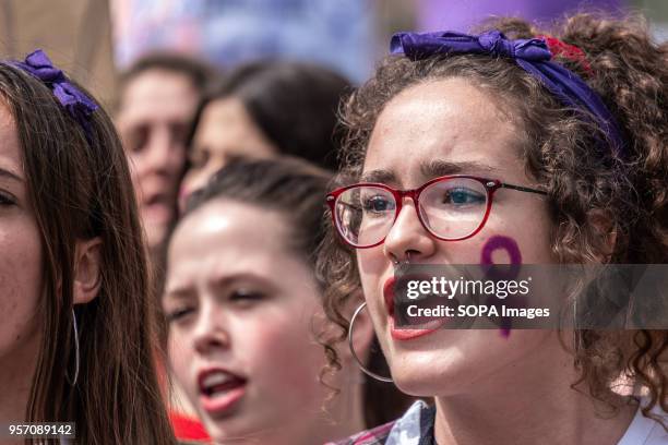 Young woman is seen screaming slogans with the sign of the woman painted on her face. Under the slogan "it's not abuse, it's rape" more than 5,000...