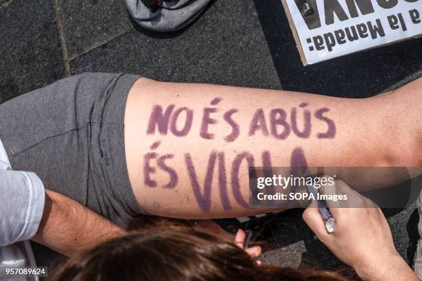 Protester is seen writing "it is not abuse, it is rape" on the body of another person. Under the slogan "it's not abuse, it's rape" more than 5,000...