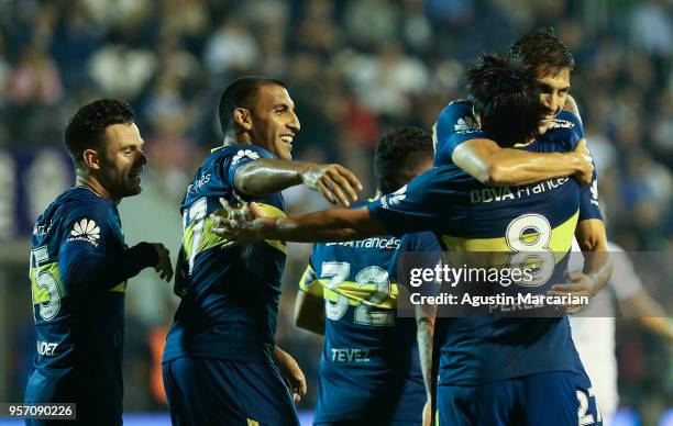 Pablo Perez of Boca Juniors celebrates with teammates Santiago Vergini, Ramon Abila and Nahitan Nandez after scoring the opening goal during a match...