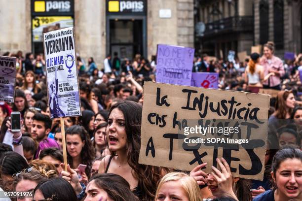 Young woman shouting slogans is seen next to a sign with the text "Injustice has violated us all". Under the slogan "it's not abuse, it's rape" more...