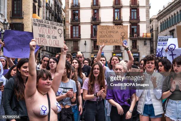 Young woman with naked breasts covered with stickers is seen showing a sign with the text "The message of the judges is clear: to show that you have...