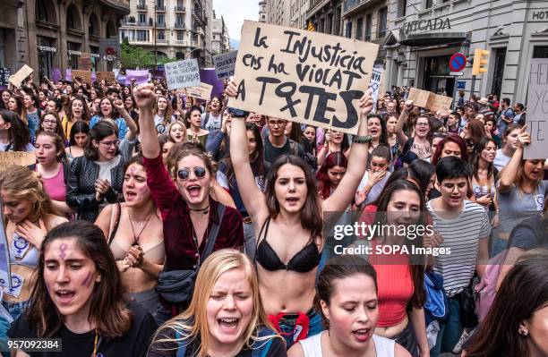 Young woman in underwear is seen showing a sign with the label "injustice violates us all". Under the slogan "it's not abuse, it's rape" more than...