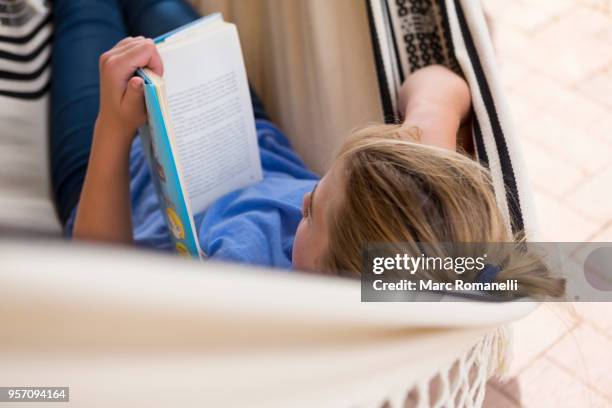 12 year old girl reading book in hammock - lamy new mexico stock pictures, royalty-free photos & images