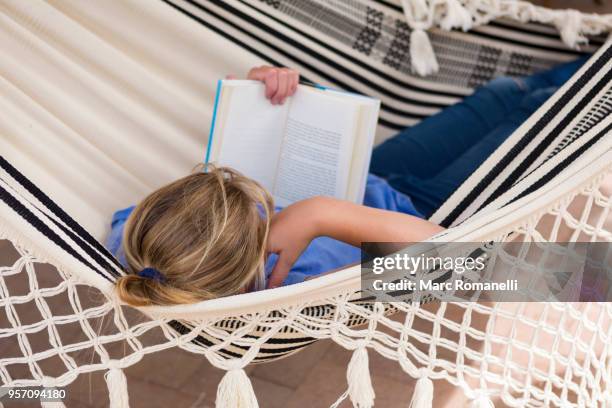 12 year old girl reading book in hammock - lamy new mexico stock pictures, royalty-free photos & images