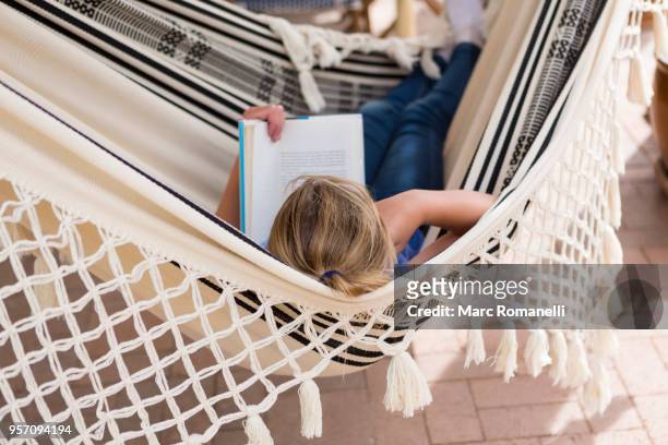 12 year old girl reading book in hammock - lamy new mexico stock pictures, royalty-free photos & images
