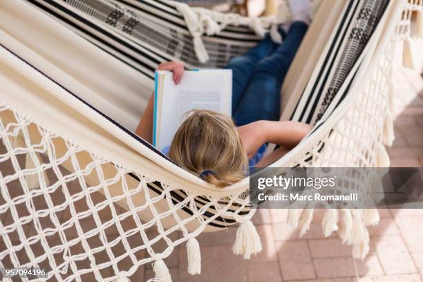 12 year old girl reading book in hammock - lamy new mexico stock pictures, royalty-free photos & images