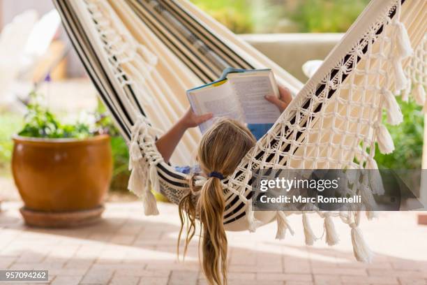 12 year old girl reading book in hammock - lamy new mexico stock pictures, royalty-free photos & images