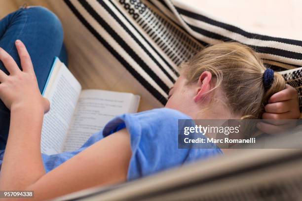 12 year old girl reading book in hammock - lamy new mexico stock pictures, royalty-free photos & images