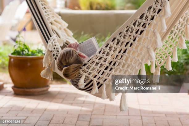 12 year old girl reading book in hammock - lamy new mexico stock pictures, royalty-free photos & images