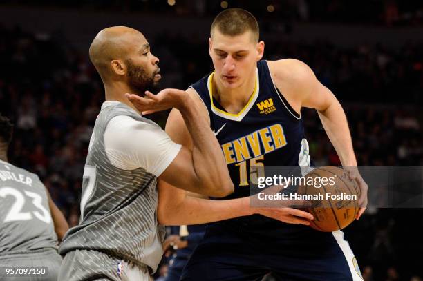 Taj Gibson of the Minnesota Timberwolves defends against Nikola Jokic of the Denver Nuggets during the game on April 11, 2018 at the Target Center in...