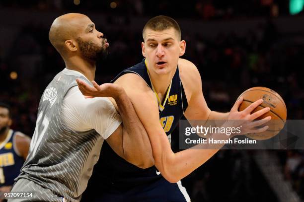 Taj Gibson of the Minnesota Timberwolves defends against Nikola Jokic of the Denver Nuggets during the game on April 11, 2018 at the Target Center in...