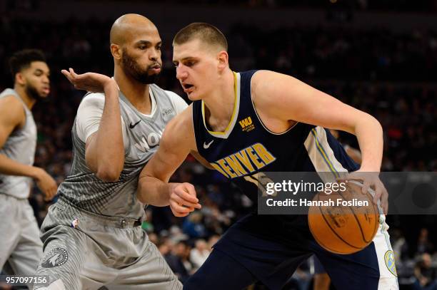 Taj Gibson of the Minnesota Timberwolves defends against Nikola Jokic of the Denver Nuggets during the game on April 11, 2018 at the Target Center in...