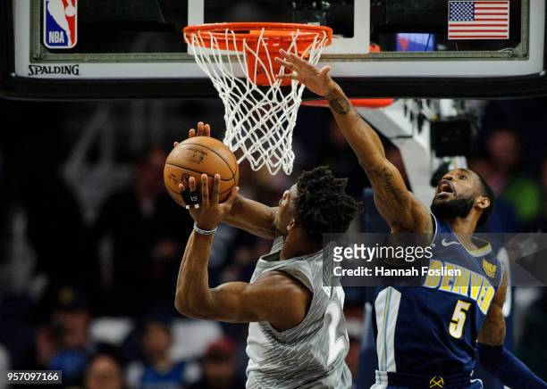 Will Barton of the Denver Nuggets defends against a shot by Jimmy Butler of the Minnesota Timberwolves during the game on April 11, 2018 at the...