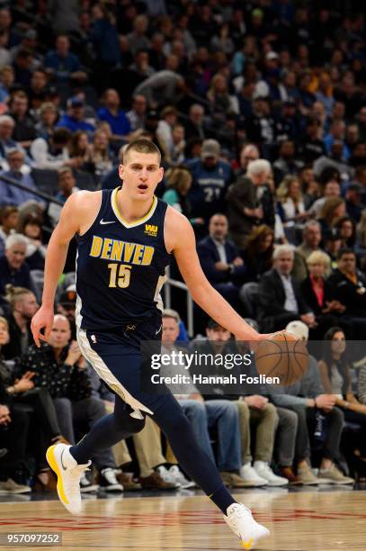 Nikola Jokic of the Denver Nuggets dribbles the ball against the Minnesota Timberwolves during the game on April 11, 2018 at the Target Center in...
