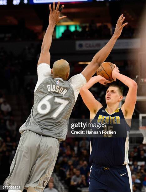 Nikola Jokic of the Denver Nuggets shoots the ball against Taj Gibson of the Minnesota Timberwolves during the game on April 11, 2018 at the Target...