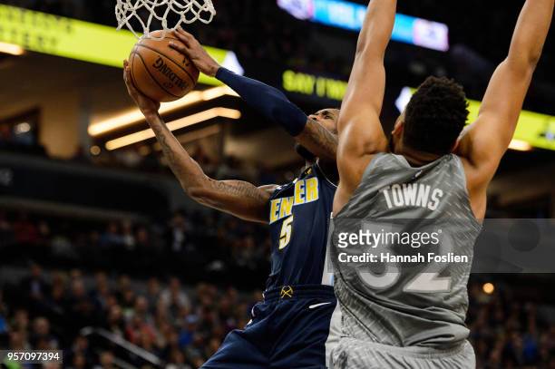 Will Barton of the Denver Nuggets shoots the ball against Karl-Anthony Towns of the Minnesota Timberwolves during the game on April 11, 2018 at the...