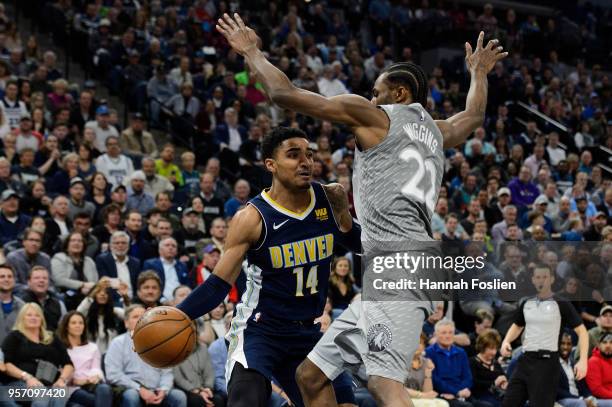 Gary Harris of the Denver Nuggets passes the ball away from Andrew Wiggins of the Minnesota Timberwolves during the game on April 11, 2018 at the...