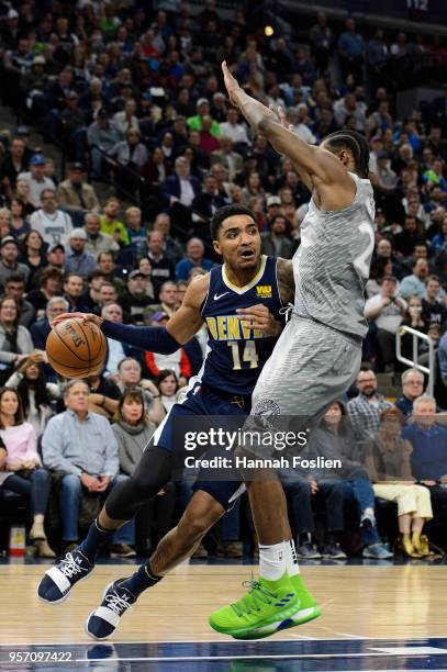 Gary Harris of the Denver Nuggets drives to the basket against Andrew Wiggins of the Minnesota Timberwolves during the game on April 11, 2018 at the...