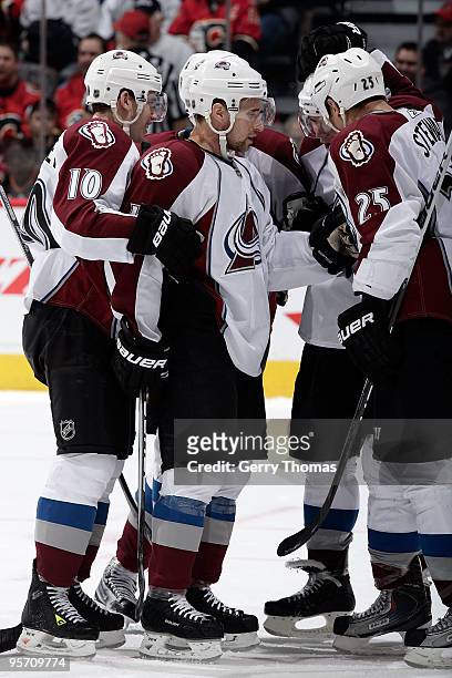 Kyle Cumiskey, Chris Stewart and teammates of the Colorado Avalanche celebrate a goal against the Calgary Flames on January 11, 2010 at Pengrowth...