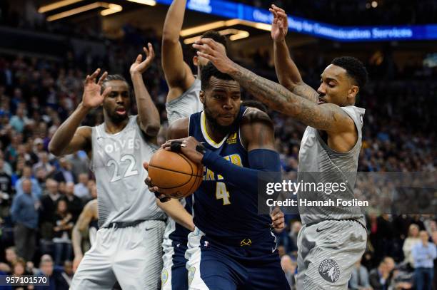 Paul Millsap of the Denver Nuggets rebounds the ball against Andrew Wiggins, Karl-Anthony Towns and Jeff Teague of the Minnesota Timberwolves during...