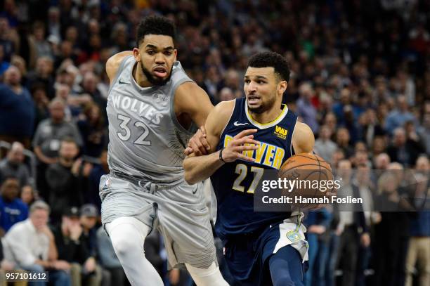 Jamal Murray of the Denver Nuggets drives to the basket against Karl-Anthony Towns of the Minnesota Timberwolves during the game on April 11, 2018 at...