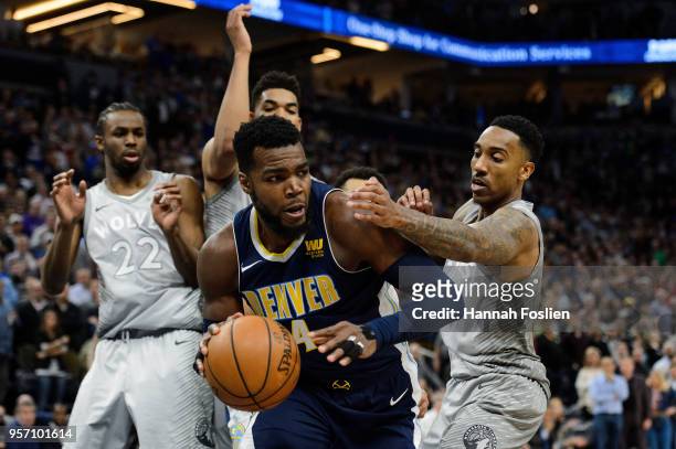 Paul Millsap of the Denver Nuggets rebounds the ball against Andrew Wiggins, Karl-Anthony Towns and Jeff Teague of the Minnesota Timberwolves during...