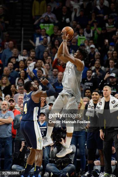 Jimmy Butler of the Minnesota Timberwolves shoots the ball against Paul Millsap of the Denver Nuggets during the game on April 11, 2018 at the Target...