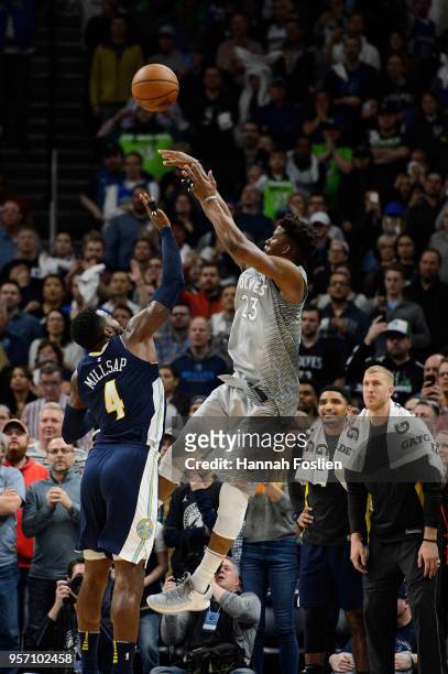 Jimmy Butler of the Minnesota Timberwolves shoots the ball against Paul Millsap of the Denver Nuggets during the game on April 11, 2018 at the Target...