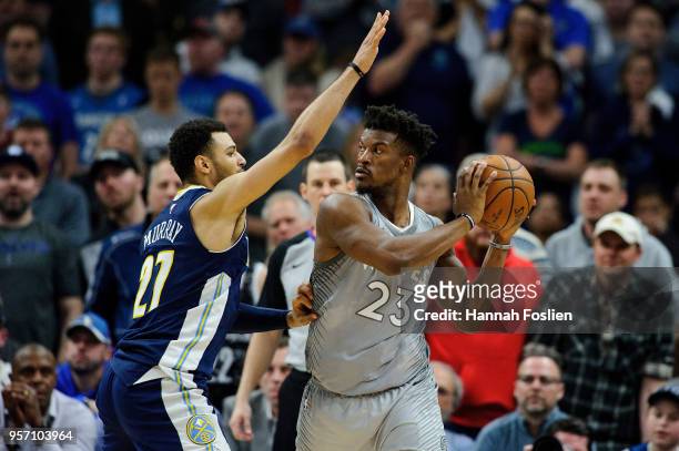 Jamal Murray of the Denver Nuggets defends against Jimmy Butler of the Minnesota Timberwolves during the game on April 11, 2018 at the Target Center...