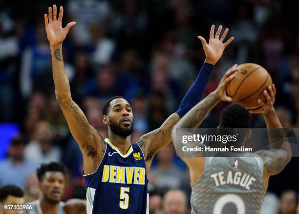 Will Barton of the Denver Nuggets defends against Jeff Teague of the Minnesota Timberwolves during the game on April 11, 2018 at the Target Center in...