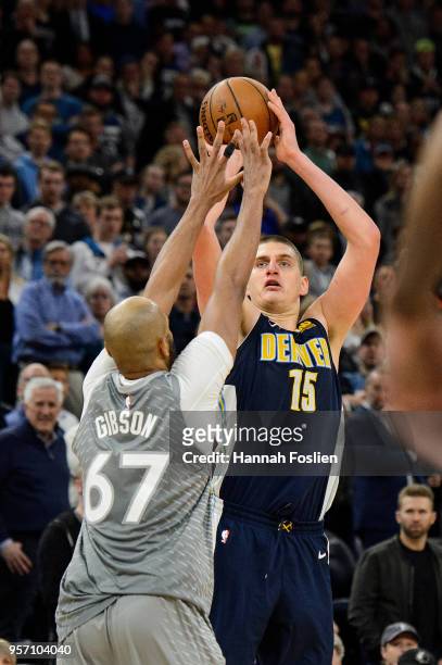 Nikola Jokic of the Denver Nuggets shoots the ball against Taj Gibson of the Minnesota Timberwolves during the game on April 11, 2018 at the Target...