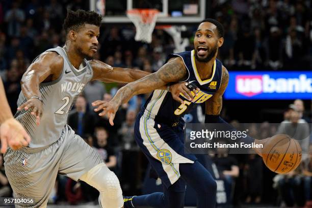 Will Barton of the Denver Nuggets dribbles the ball against Jimmy Butler of the Minnesota Timberwolves during the game on April 11, 2018 at the...
