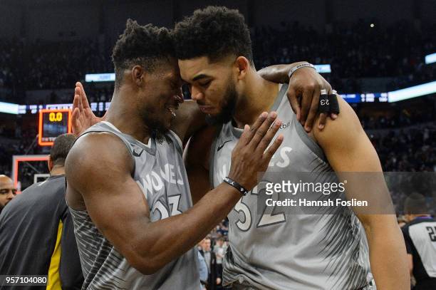 Jimmy Butler and Karl-Anthony Towns of the Minnesota Timberwolves celebrate defeating the Denver Nuggets after the game on April 11, 2018 at the...
