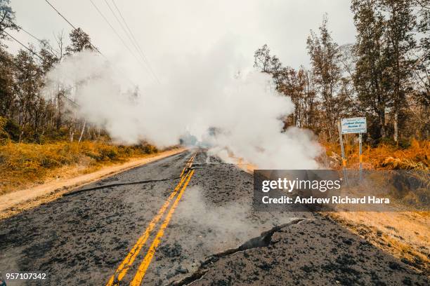 Cracks and volcanic debris are seen on a road on May 9, 2018 in Leilani Estates, Hawaii. The first Hawaiian house was consumed this week by the...