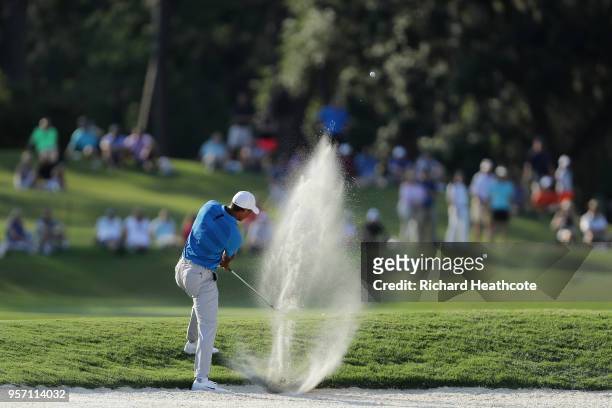 Tiger Woods of the United States plays a shot from a bunker on the 15th hole during the first round of THE PLAYERS Championship on the Stadium Course...