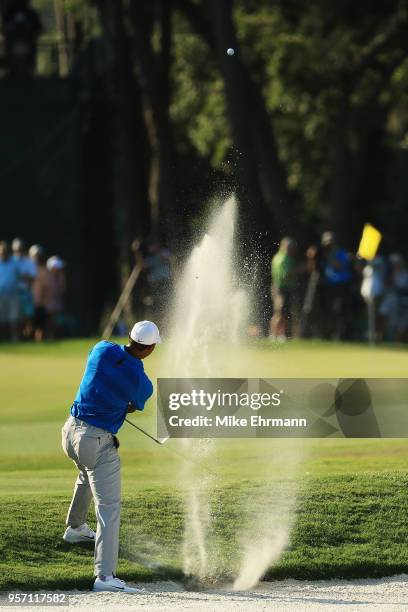 Tiger Woods of the United States plays a shot from a bunker on the 15th hole during the first round of THE PLAYERS Championship on the Stadium Course...