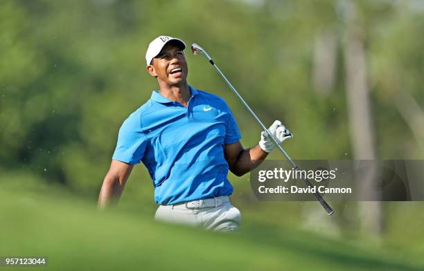 Tiger Woods of the United States reacts to his second shot on the par 4, 14th hole during the first round of the THE PLAYERS Championship on the...