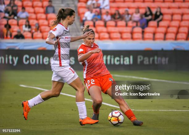 Houston Dash defender Amber Brooks attempts to intercept the ball dribbled by Portland Thorns FC midfielder Tobin Heath during the soccer match...