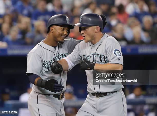 Kyle Seager of the Seattle Mariners is congratulated by Jean Segura after hitting a grand slam home run in the first inning during MLB game action...