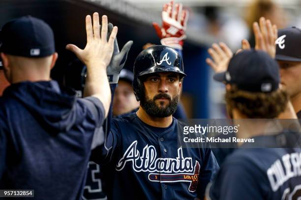 Nick Markakis of the Atlanta Braves celebrates with teammates after scoring a run in the second inning against the Miami Marlins at Marlins Park on...