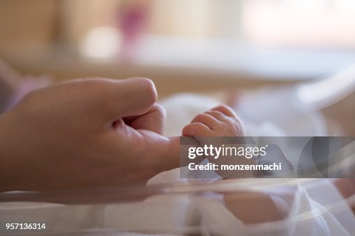 Newborn baby holding mother's hand Newborn baby holding mother's hand